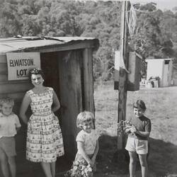 Digital Photograph - Woman, Two Girls & Boy, in front of Builder's Shed, close view, House Building Site, Greensborough, circa 1958