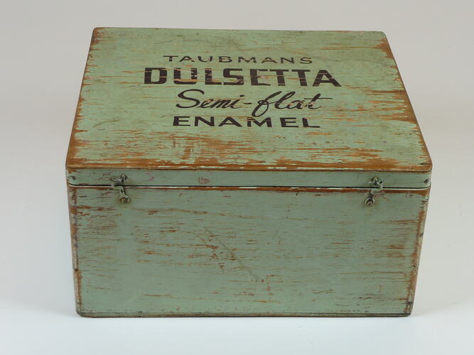 Wooden box painted green with the lid closed.