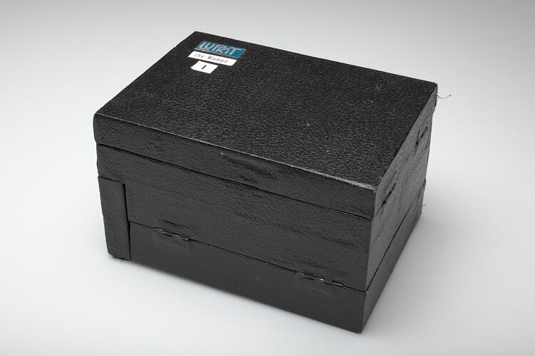 Wooden box with small labels.