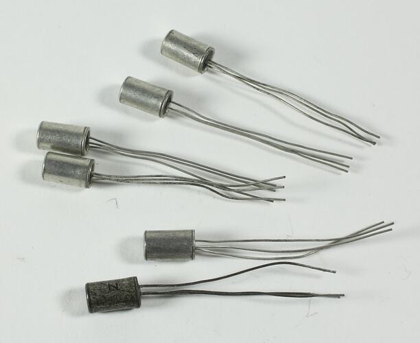 Six silver metal transistors each with three protruding wires.