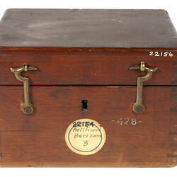 Closed wooden box with two metal latches.
