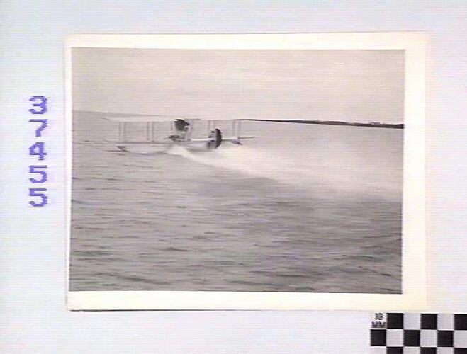 Seaplane taking off from water.