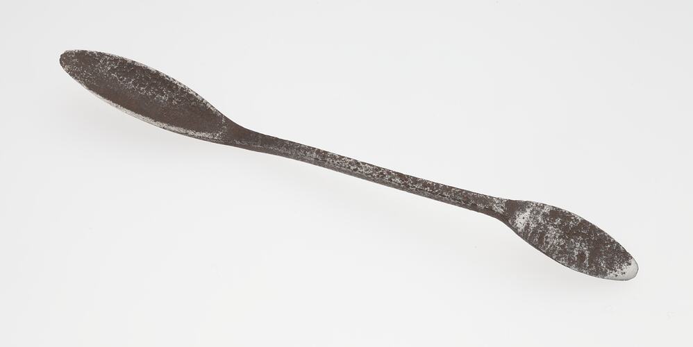 A rusted spoon shaped tool.
