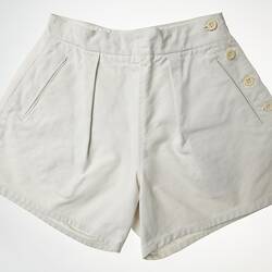 Woman's white canvas shorts, four buttons on the right side.