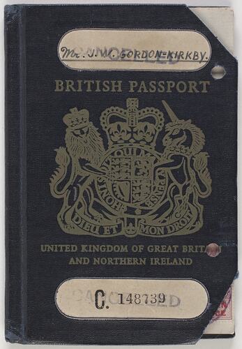 Dark blue passport front cover with gold printing. Coat of arms in centre. Two cut out sections.