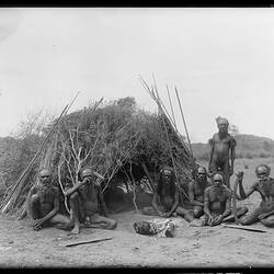 Arrernte Elders in front of a bough shelter, Alice Springs, Central Australia, c. 1896.