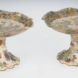 Pair of cream coloured compote with wavy edges decorated with birds & chrysanthemums.