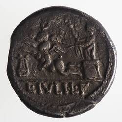 Round coin, aged, figure in chariot holding reigns and sceptre, facing left.