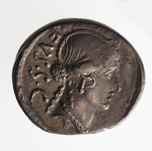 Round coin, aged, female profile, facing right, wearing headdress.