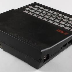 Black computer console with type face, back view.