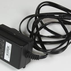 Black electrical cord with adaptor.