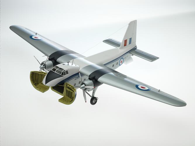 Metal silver, blue, white model aeroplane. Two propellers on wings. Cargo doors open at nose.