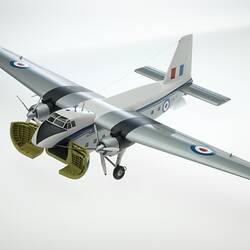 Metal silver, blue, white model aeroplane. Two propellers on wings. Cargo doors open at nose.