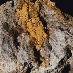 Gold on a grey rock.