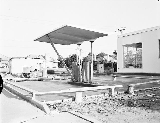 Monochrome photograph of a petrol station.