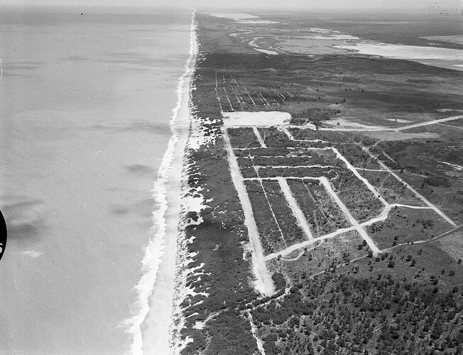 Monochrome aerial photograph of a beach.