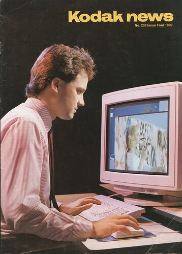 Cover with photograph of man at computer.