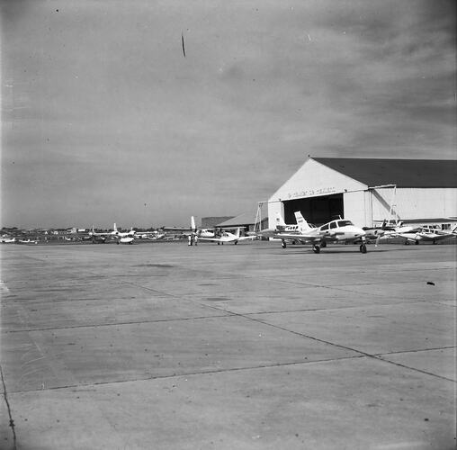 Monochrome image of an aircraft hangar.