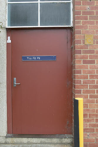 Red door with blue sign.