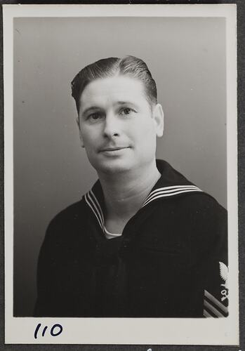 Studio portrait of a man in Navy uniform.