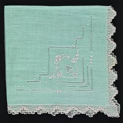 Folded Green Linen handkerchief with Embroidered Motif.