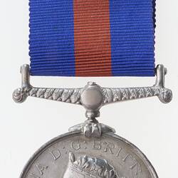 Silver medal with profile of crowned woman and blue and red ribbon attached.