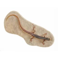Cast model of brown lizard with bold white stripes.