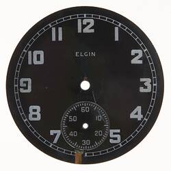 Round dark watch dial with light coloured numbers and markings.