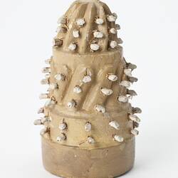 Miniature spiky brown cake from a doll's house.