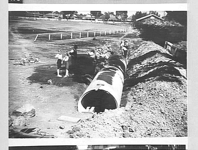 Concrete pipes in open trench.