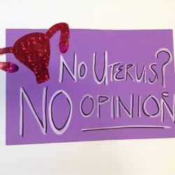 Purple poster with black and white text. Red uterus top left corner.