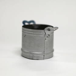Side view of tiny aluminium pot showing seam.