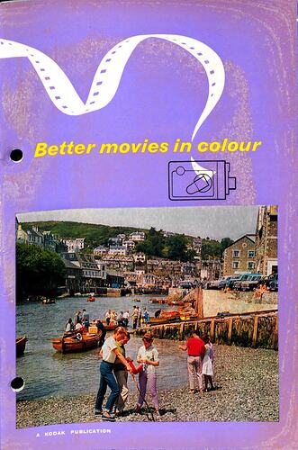 Purple cover page with busy scene of boat filled river in town set on hill. People stand on the stony bank.