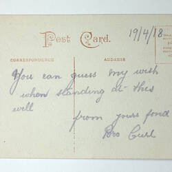 Printed back of postcard with handwriting.
