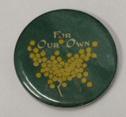 Green round badge with text and yellow wattle flower.