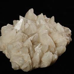 White/cream mineral with pointy crystals.