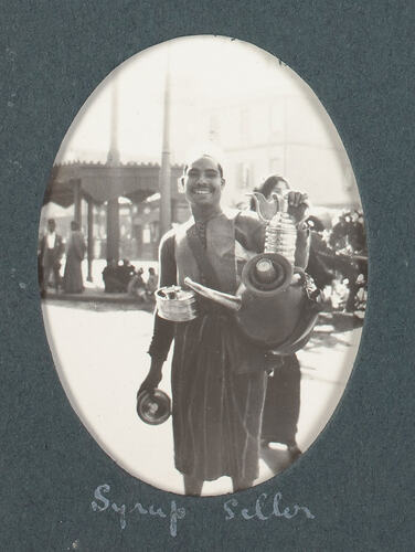 Smiling man holding containers with spouts.