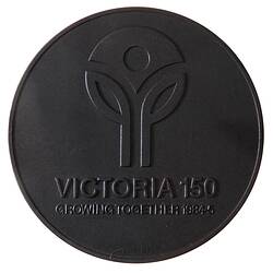Round medal with logo of two single leaf stems supporting central inverted triangle. Text below.