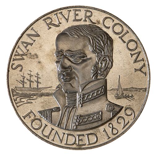 Round silver-coloured medal with bust of naval man facing left. Sailing ships in background. Text around edge.