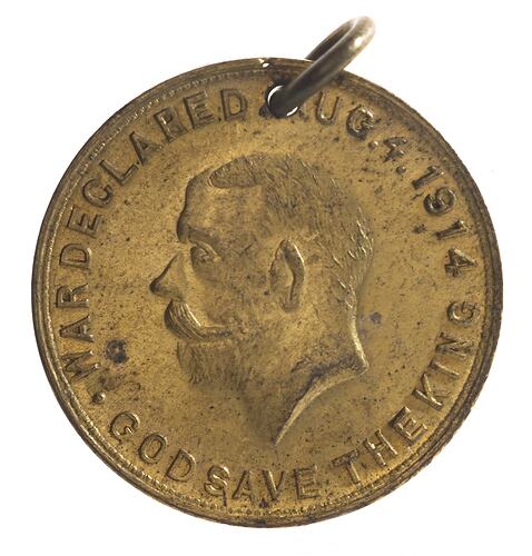 Medal with man facing left, text around.