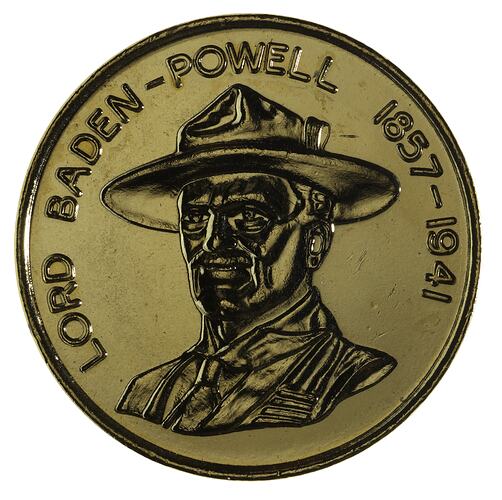 Round medal featuring uniformed man with hat.