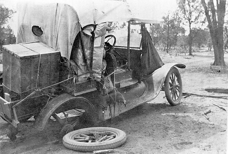 [A mail delivery car with a broken wheel, Euston, NSW, about 1920.]