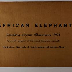 Brown rectangular label with black text.