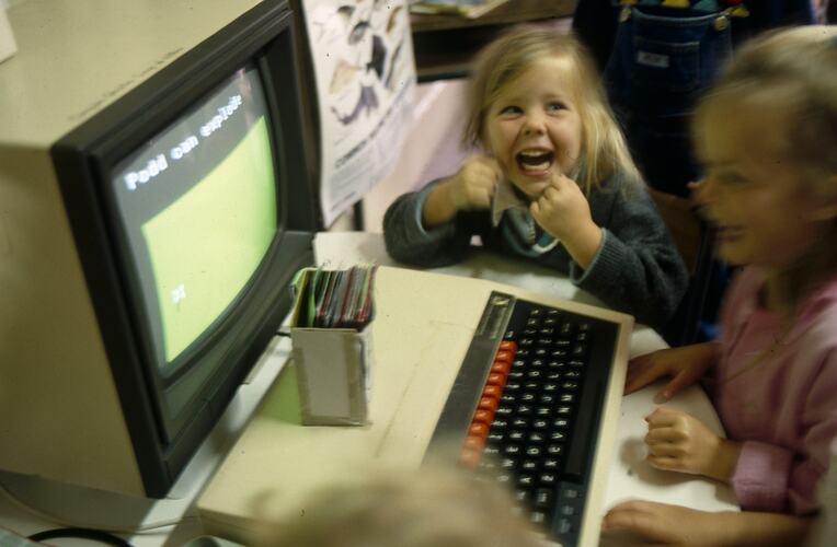 Very young students looking at a computer screen.