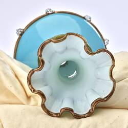 Top view of pale opaque blue glass vase with gilded frill edge. White interior.
