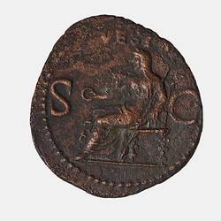 Irregular round coin with seated veiled female figure holding a patera and sceptre, facing left.