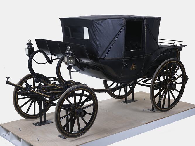 Black coach with four rubber tyres. Yellow and brown lining, and the Australian coat of arms on each door.