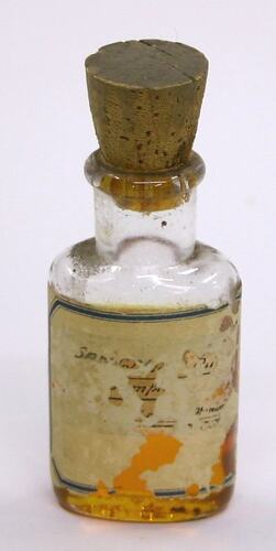 Side view of bottle with cork.