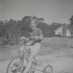 Digital Photograph - Girl Riding Tricycle Near New House, Mount Waverley, 1958