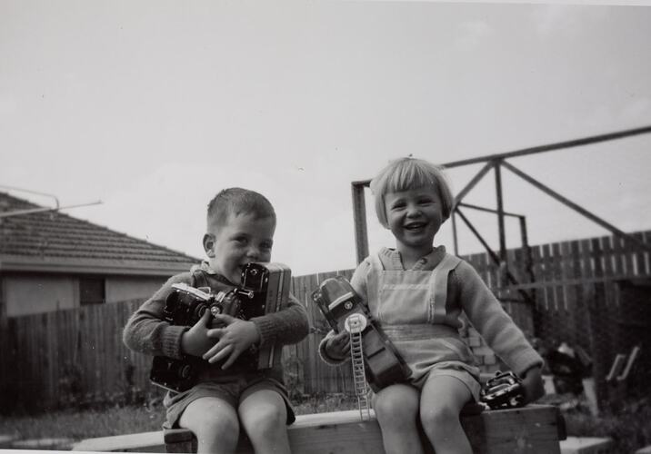Digital Photograph - Boy & Girl with Collection of Toy Fire Trucks & Buses, Backyard, Glenroy, 1960-1961